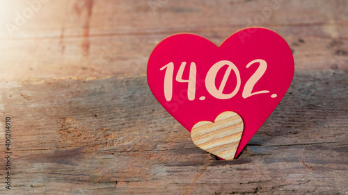 Happy Valentine's Day 14.02. greeting card template background - Two hearts made of wood on wooden table texture