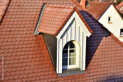 Renovierte Dachgauben mit Schiefer-Schindel-Verkleidung als Wetterschutz an einem denkmalgeschützten Wohngebäude