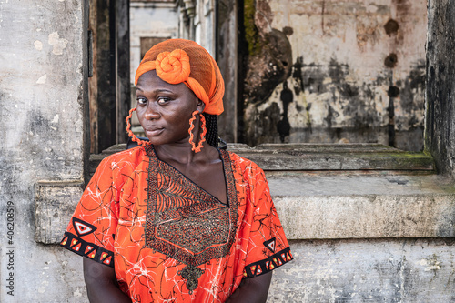 Africa Woman stands at an old building from colonization in Takoradi Ghana. photo