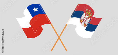 Crossed and waving flags of Chile and Serbia
