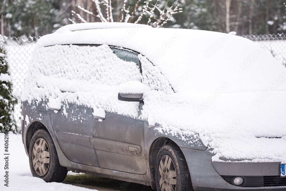 Serock, Poland - January 13, 2021: Family car covered with a blanket of snow. Precipitation in winter.