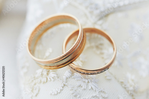 golden wedding rings on a white lace background. wedding ceremony