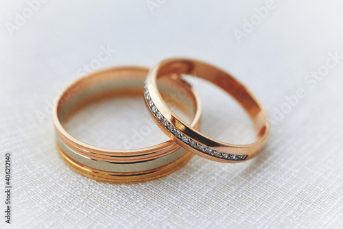 golden wedding rings on a white lace background. wedding ceremony