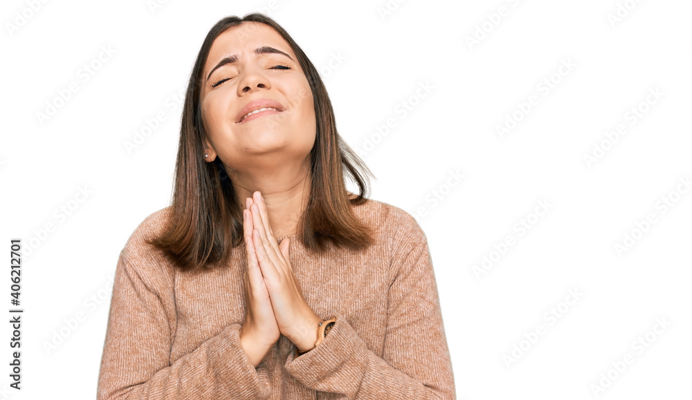 Young beautiful woman wearing casual clothes begging and praying with hands together with hope expression on face very emotional and worried. begging. Young beautiful woman wearing casual clothes begging and praying with hands together with hope expression on face very emotional and worried. begging.