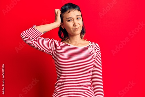 Young woman wearing casual clothes confuse and wonder about question. uncertain with doubt, thinking with hand on head. pensive concept.
