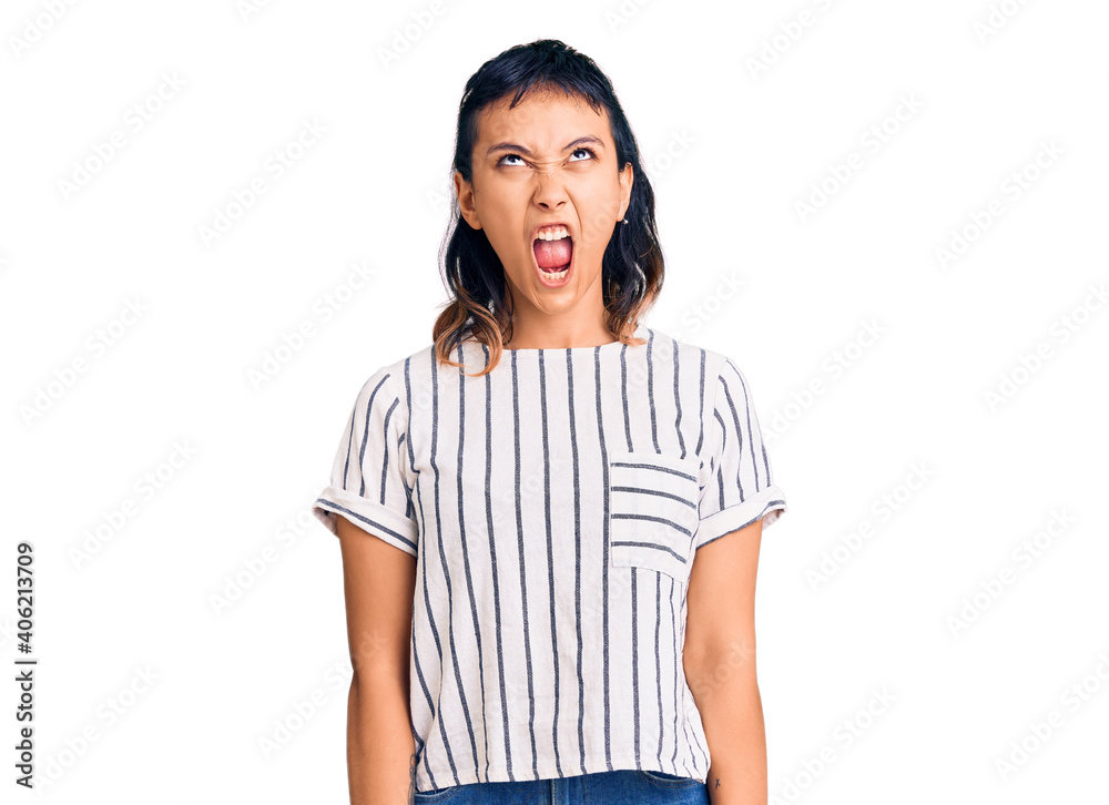 Young woman wearing casual clothes angry and mad screaming frustrated and furious, shouting with anger. rage and aggressive concept. Young woman wearing casual clothes angry and mad screaming frustrated and furious, shouting with anger. rage and aggressive concept.