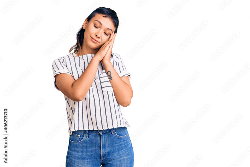 Young woman wearing casual clothes sleeping tired dreaming and posing with hands together while smiling with closed eyes. Young woman wearing casual clothes sleeping tired dreaming and posing with hands together while smiling with closed eyes.