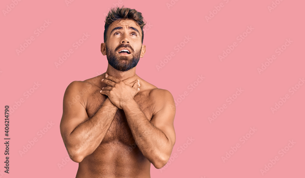 Fototapeta premium Young hispanic man wearing swimwear shirtless shouting and suffocate because painful strangle. health problem. asphyxiate and suicide concept.