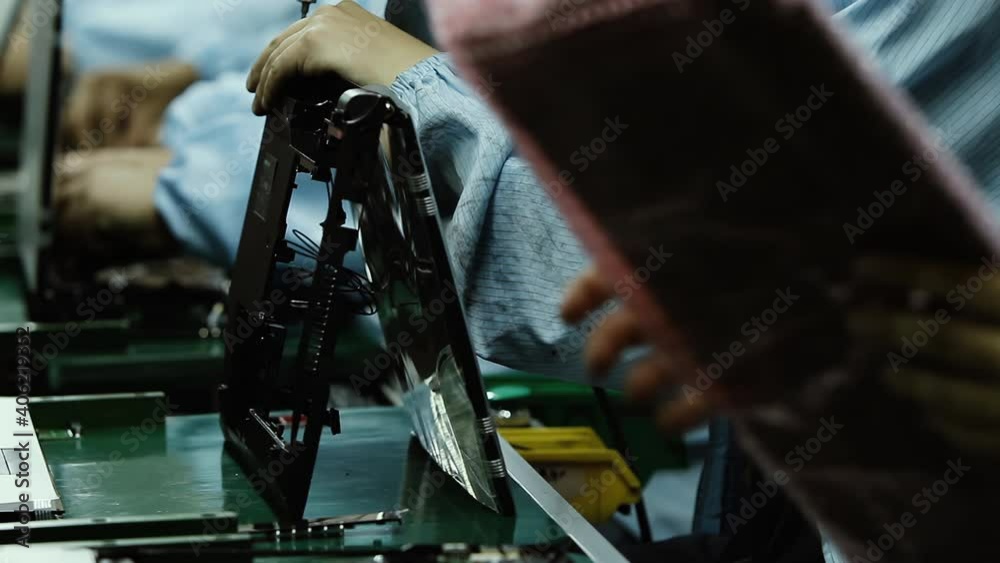 Assembly Workers installing Electronic Components on Laptop Computers at the Plant. 4K Resolution. Assembly Workers installing Electronic Components on Laptop Computers at the Plant. 4K Resolution.