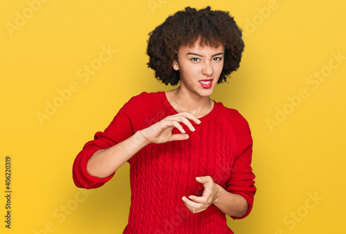 Young hispanic girl wearing casual clothes disgusted expression, displeased and fearful doing disgust face because aversion reaction. with hands raised