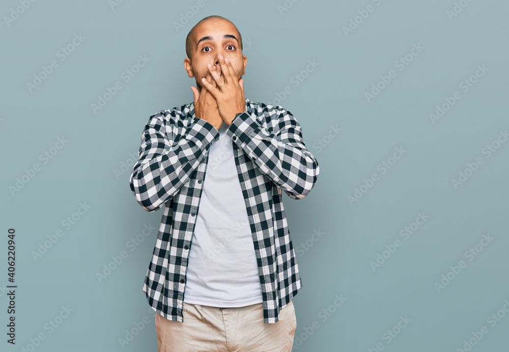 Hispanic adult man wearing casual clothes shocked covering mouth with hands for mistake. secret concept. Hispanic adult man wearing casual clothes shocked covering mouth with hands for mistake. secret concept.