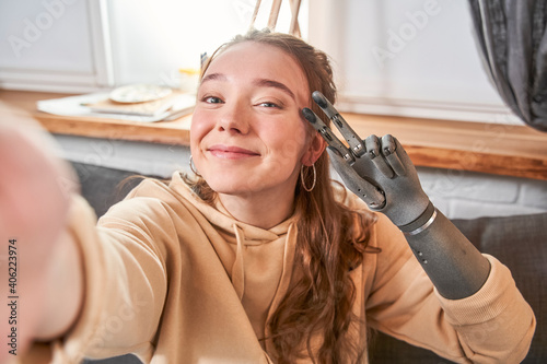 Photos Woman with artificial limb making selfie photo