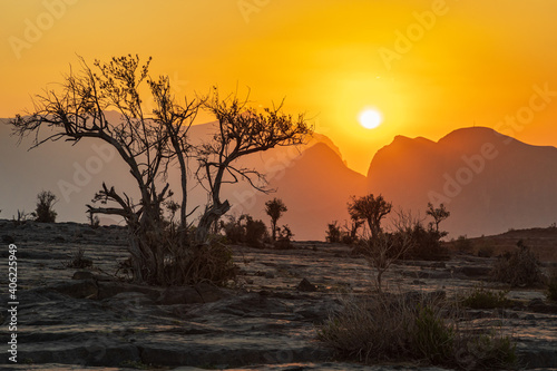 The sun setting over mountains in the desert of Oman.