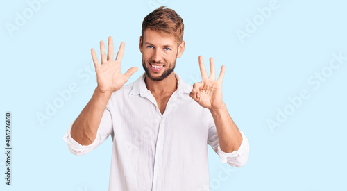 Young caucasian man wearing casual clothes showing and pointing up with fingers number eight while smiling confident and happy.