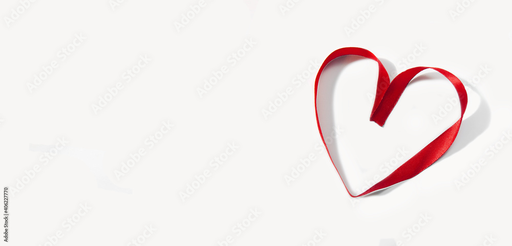red ribbon folded in the shape of a heart, isolate