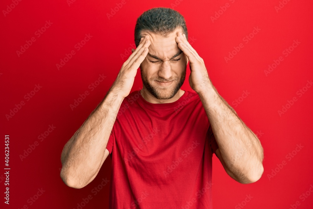 Young caucasian man wearing casual clothes with hand on head, headache because stress. suffering migraine. Young caucasian man wearing casual clothes with hand on head, headache because stress. suffering migraine.