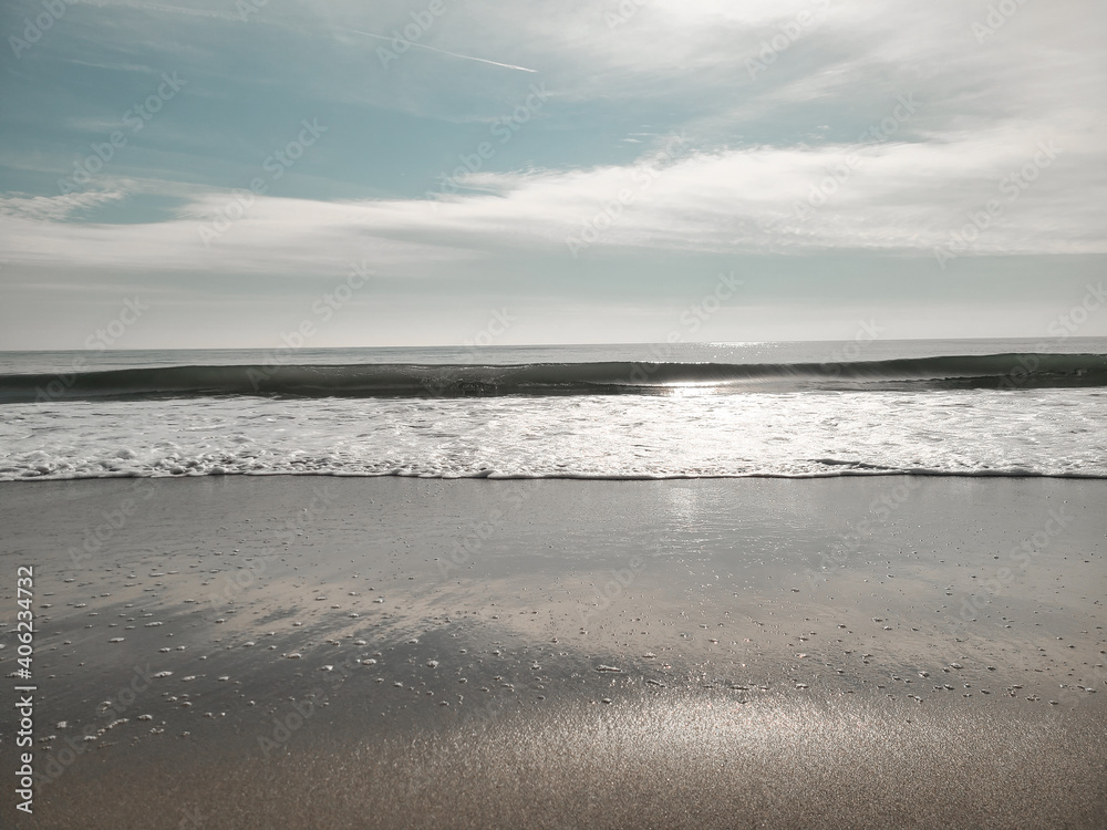 A minimal beach shore. Soft wave of the Ocean on the sandy beach. Rockaway Beach, New York. A minimal beach shore. Soft wave of the Ocean on the sandy beach. Rockaway Beach, New York.