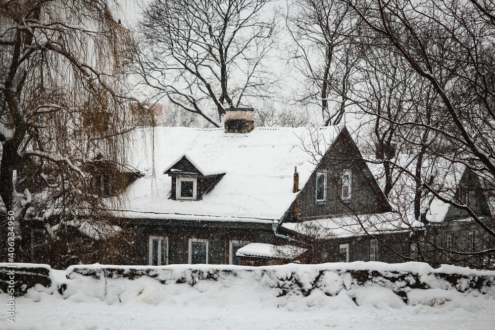 Old house surrounded by leafless trees covered in snow Old house surrounded by leafless trees covered in snow