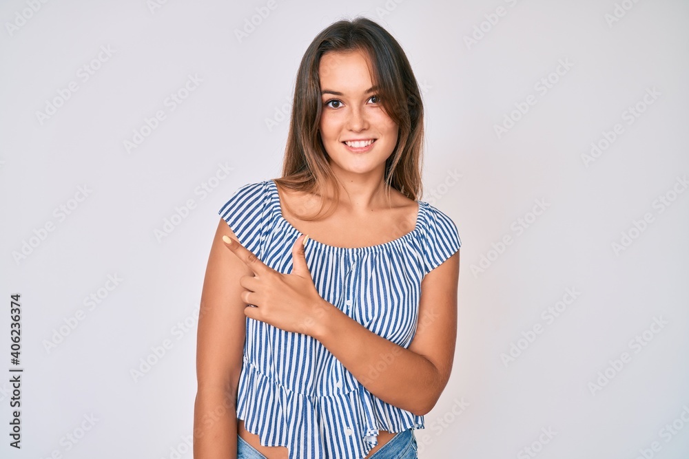Beautiful caucasian woman wearing casual striped shirt smiling cheerful pointing with hand and finger up to the side Beautiful caucasian woman wearing casual striped shirt smiling cheerful pointing with hand and finger up to the side