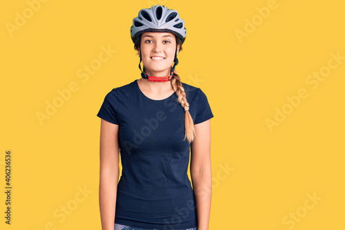 Beautiful caucasian woman wearing bike helmet with a happy and cool smile on face. lucky person.
