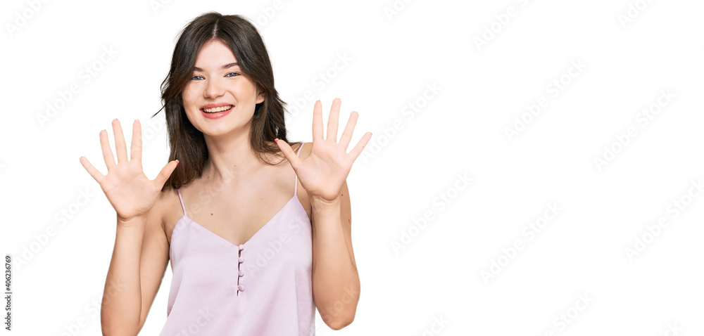 Young beautiful caucasian girl wearing casual clothes showing and pointing up with fingers number ten while smiling confident and happy. Young beautiful caucasian girl wearing casual clothes showing and pointing up with fingers number ten while smiling confident and happy.