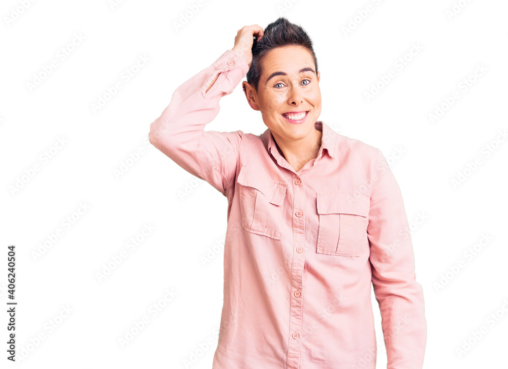 Young woman with short hair wearing casual clothes smiling confident touching hair with hand up gesture, posing attractive and fashionable Young woman with short hair wearing casual clothes smiling confident touching hair with hand up gesture, posing attractive and fashionable