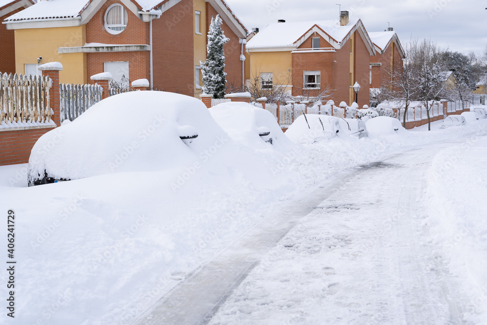 Long row of cars fully covered of snow in Madrid Mountains