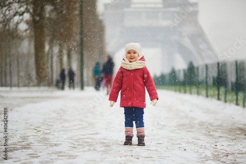 Adorable toddler girl near the Eiffel tower on a day with heavy snowfall in Paris, France © Ekaterina Pokrovsky