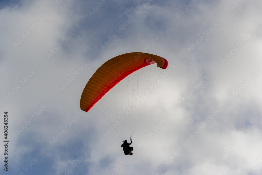 A beautiful view of a paraglide flying gliding on a clear blue sky at the golden hour with a nice wind windy breeze on a sunny day A beautiful view of a paraglide flying gliding on a clear blue sky at the golden hour with a nice wind windy breeze on a sunny day