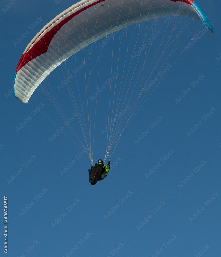A beautiful view of a paraglide flying gliding on a clear blue sky at the golden hour with a nice wind windy breeze on a sunny day A beautiful view of a paraglide flying gliding on a clear blue sky at the golden hour with a nice wind windy breeze on a sunny day