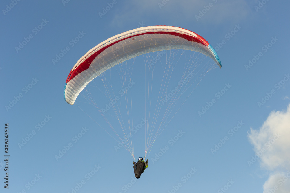 A beautiful view of a paraglide flying gliding on a clear blue sky at the golden hour with a nice wind windy breeze on a sunny day A beautiful view of a paraglide flying gliding on a clear blue sky at the golden hour with a nice wind windy breeze on a sunny day