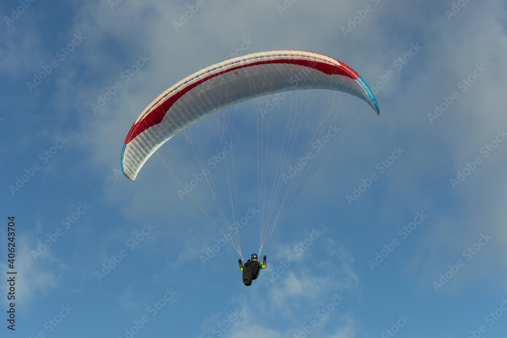 A beautiful view of a paraglide flying gliding on a clear blue sky at the golden hour with a nice wind windy breeze on a sunny day A beautiful view of a paraglide flying gliding on a clear blue sky at the golden hour with a nice wind windy breeze on a sunny day