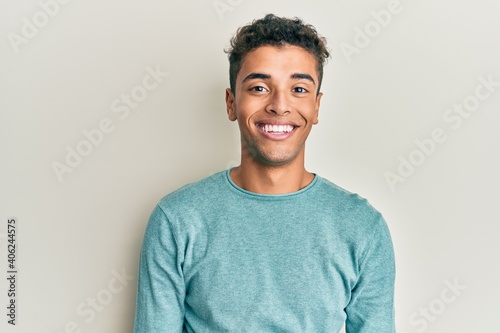 Young handsome african american man wearing casual clothes with a happy and cool smile on face. lucky person. photo