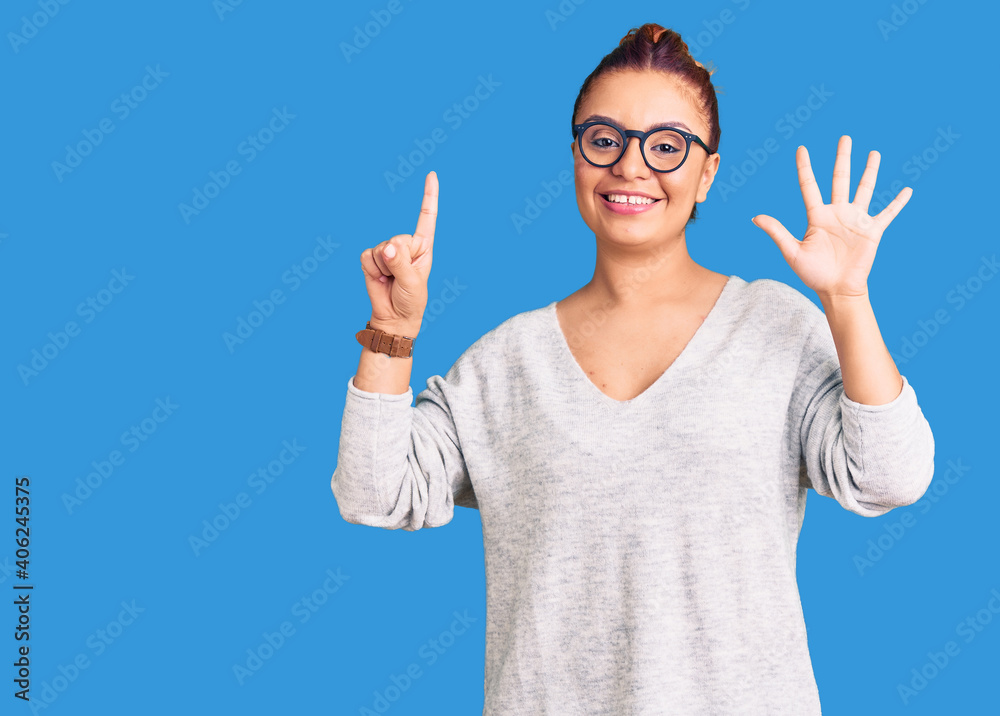Young latin woman wearing casual clothes showing and pointing up with fingers number six while smiling confident and happy. Young latin woman wearing casual clothes showing and pointing up with fingers number six while smiling confident and happy.