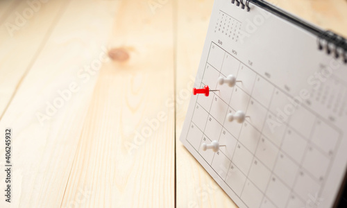 Calendar on wooden table with copy space, business meeting schedule, trip planning or project goals and reminder ideas. photo