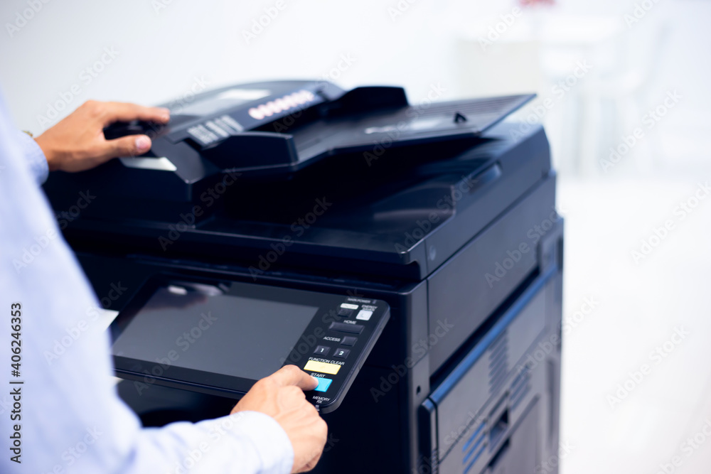 Bussiness man Hand press button on panel of printer, printer scanner laser in office copy machine supplies start concept. Bussiness man Hand press button on panel of printer, printer scanner laser in office copy machine supplies start concept.