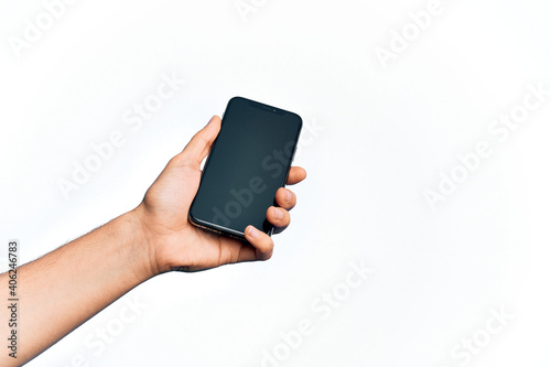 Hand of caucasian young man holding smartphone showing screen over isolated white background