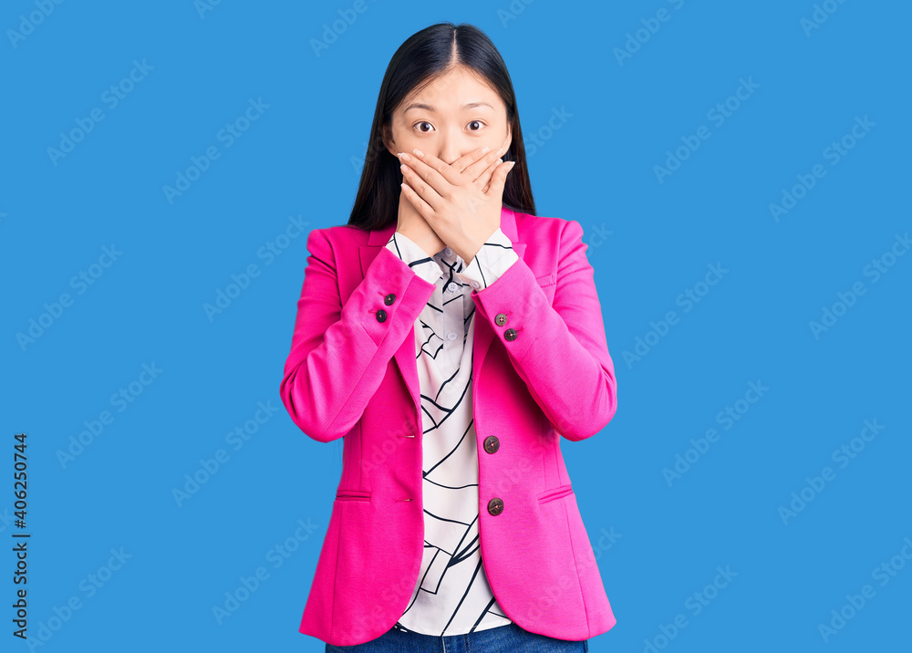 Young beautiful chinese woman wearing elegant clothes shocked covering mouth with hands for mistake. secret concept. Young beautiful chinese woman wearing elegant clothes shocked covering mouth with hands for mistake. secret concept.