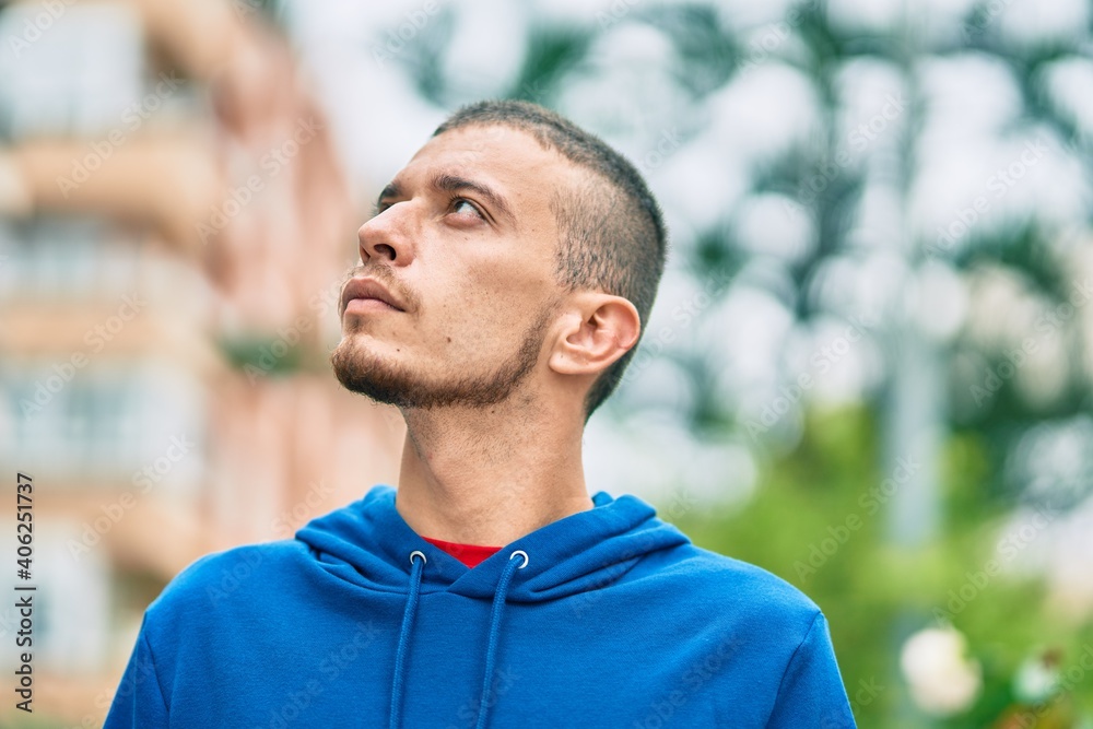 Young hispanic man with serious expression standing at the city. Young hispanic man with serious expression standing at the city.