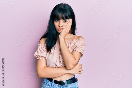 Young hispanic girl wearing casual clothes thinking looking tired and bored with depression problems with crossed arms.
