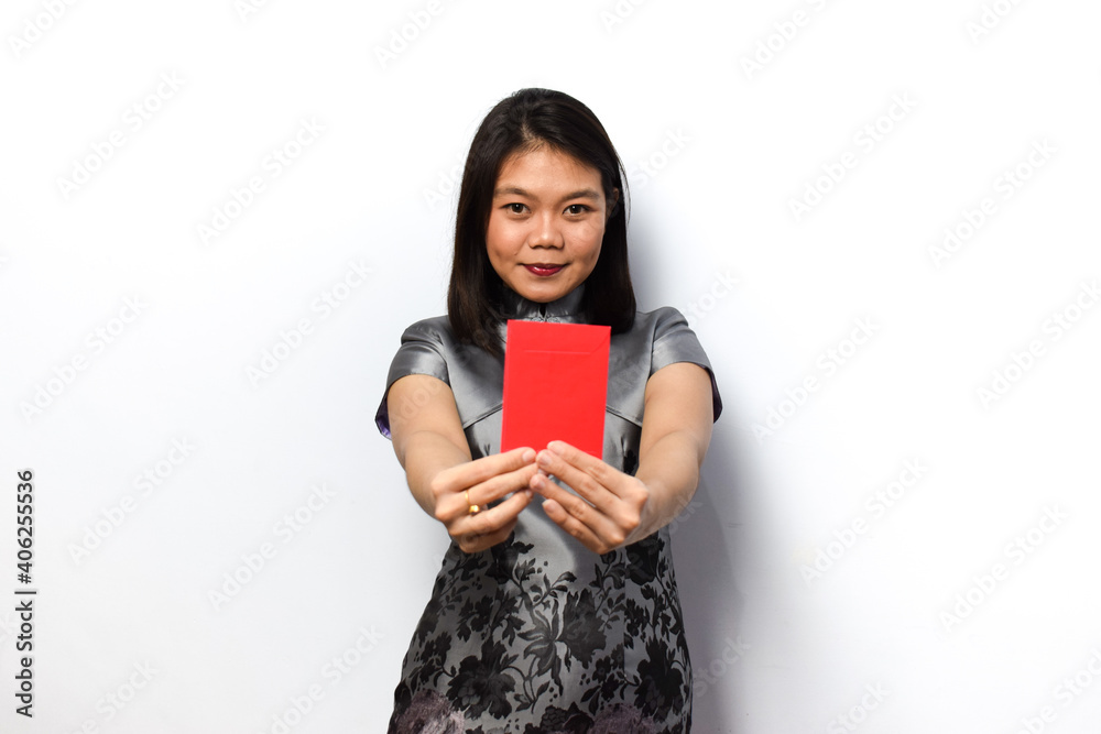 Asian Woman Dress Traditional Cheongsam, Hold Red Envelope (Angpau) and Give It To You Isolated on White Background Asian Woman Dress Traditional Cheongsam, Hold Red Envelope (Angpau) and Give It To You Isolated on White Background