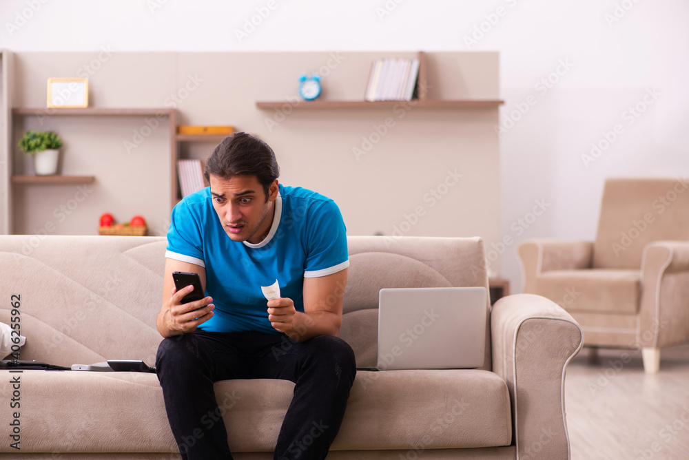 Sport bet addicted young man betting at home Sport bet addicted young man betting at home