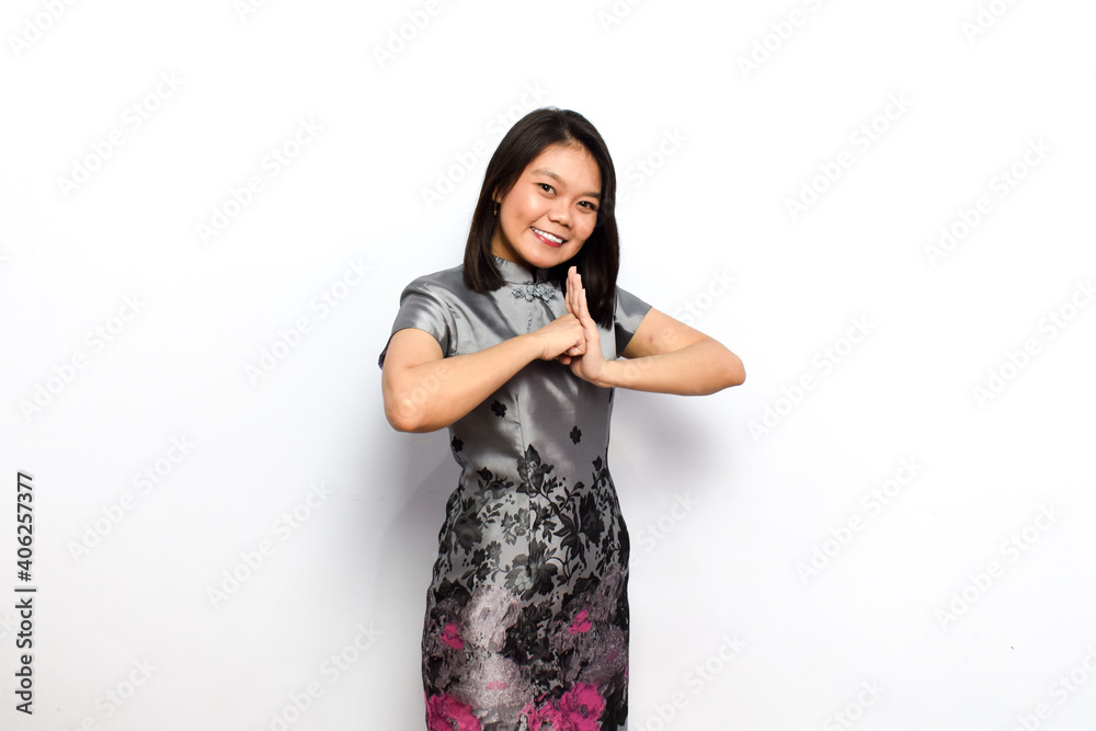 Asian Woman Dress Traditional Cheongsam, Gesture of Congratulation and Celebrate Chinese New Year Concept Isolated on White Background Asian Woman Dress Traditional Cheongsam, Gesture of Congratulation and Celebrate Chinese New Year Concept Isolated on White Background