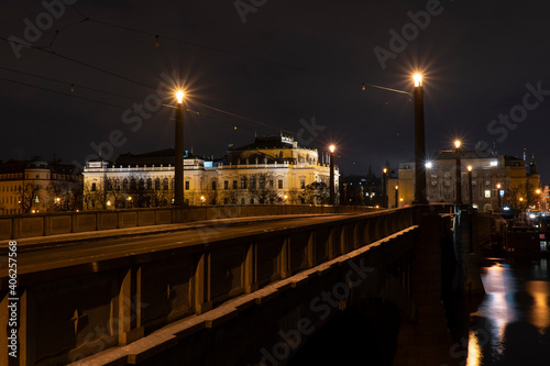 .Charles Bridge on the Vltava River and light from street lights in the center of Prague in winter