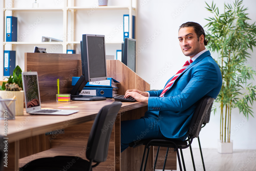 Young male employee working in the office Young male employee working in the office