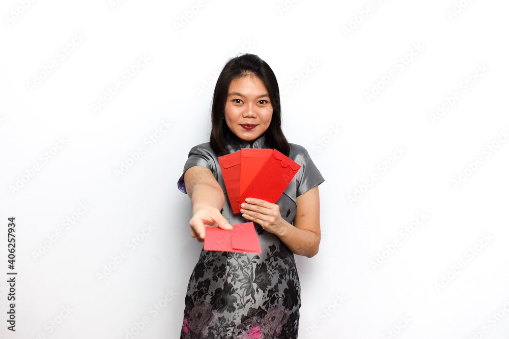 Asian Woman Dress Traditional Cheongsam, Hold Red Envelope (Angpau) and Give It To You Isolated on White Background Asian Woman Dress Traditional Cheongsam, Hold Red Envelope (Angpau) and Give It To You Isolated on White Background