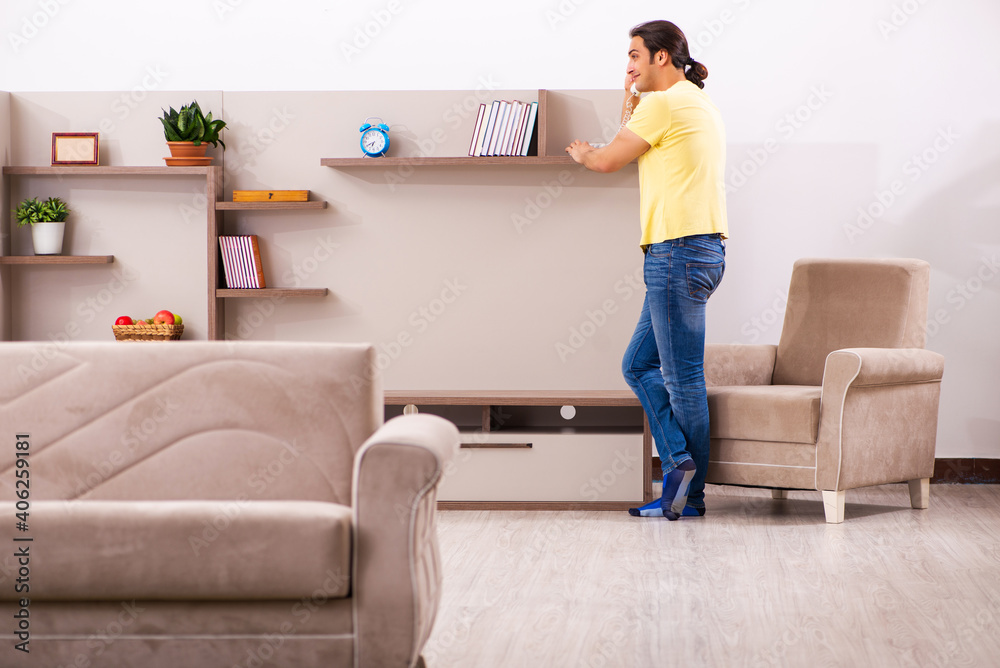 Young man student talking by phone at home Young man student talking by phone at home
