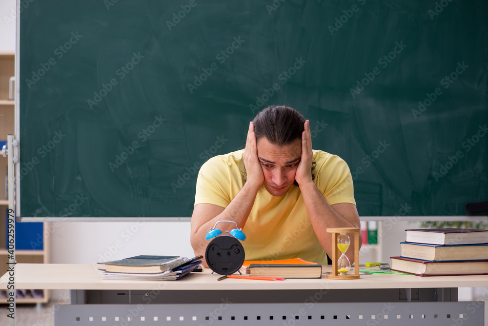 Young male student preparing for exams in the classroom Young male student preparing for exams in the classroom