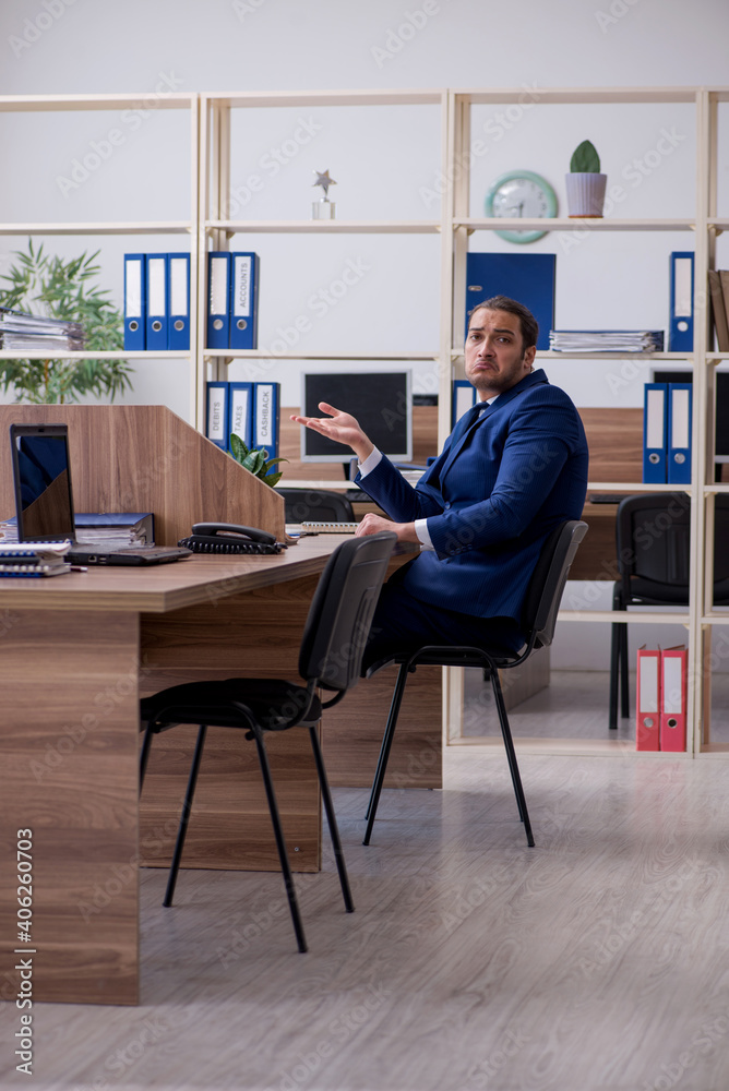 Young male employee working in the office Young male employee working in the office