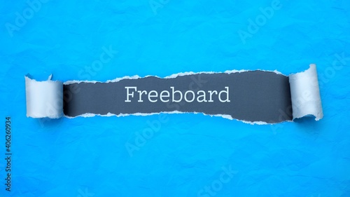 Freeboard. Blue torn paper banner with text label. Word in gray hole. photo